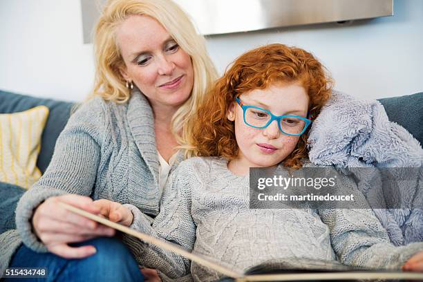 reading time for mother and daughter at home. - kids reading glasses stock pictures, royalty-free photos & images