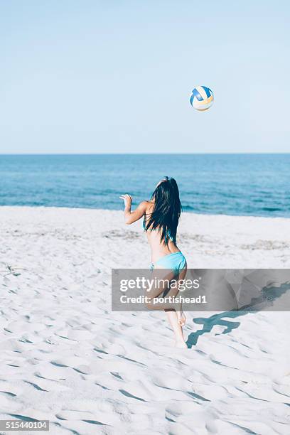 young woman playing volleyball on the beach - girls beach volleyball stock pictures, royalty-free photos & images