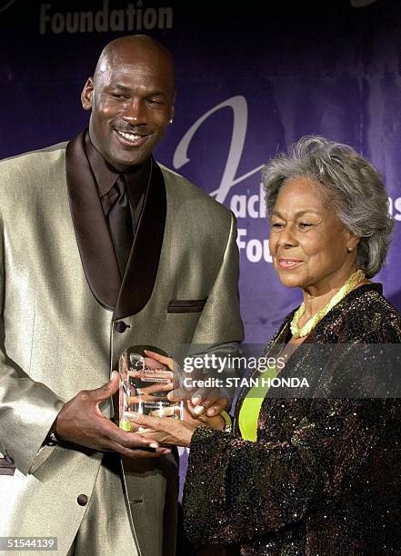 Former basketball star Michael Jordan accepts the Jackie Robinson Foundation "Robie" Award for Humanitarianism from Rachel Robinson, widow of...