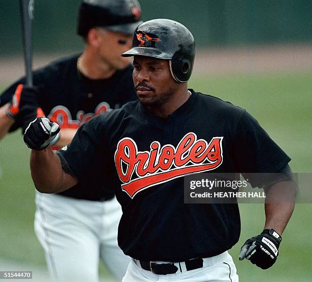 Baltimore Orioles' player Albert Belle is greeted by teammates after hitting a homerun in the second inning against the Minnesota Twins 18 March 2000...