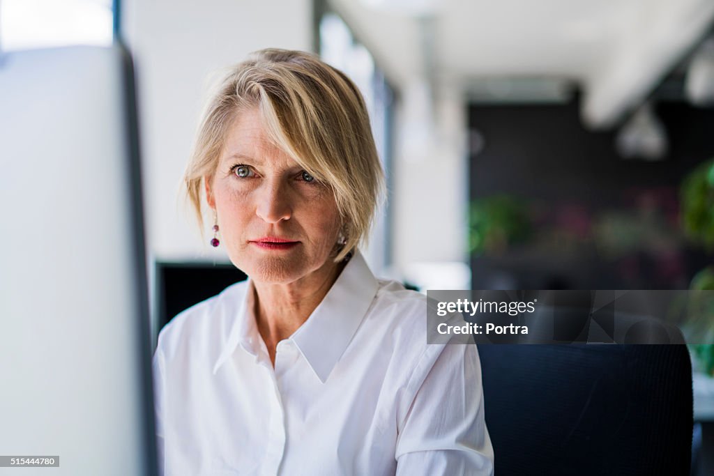 Confident businesswoman using computer