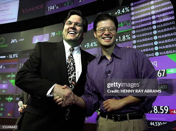 Yahoo! Inc. Co-founder Jerry Yang shakes hands with NASDAQ Vice-President for Global Sales Brian Wilson after Yang rang the opening bell to begin...