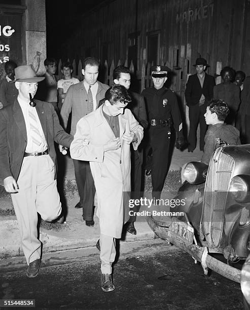 Watts, California- Police officers take this zoot suit clad youngster into custody after the sixth day of undeclared war on the reat pleat in Los...
