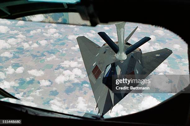 An F-117A Stealth fighter, en route to the Middle East and a supporting role in Operation Desert Shield, is refueled by a Stratotanker somewhere over...