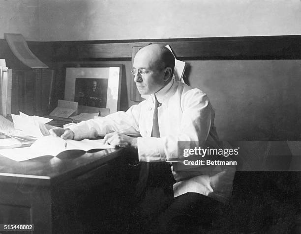 Portrait of Alexis Carrel , French surgeon and biologist. Photograph of him working at his desk.