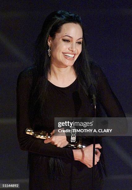 Angelina Jolie holds her Oscar for Best Performance by a Supporting Actress in a Leading Role during the 72nd Academy Awards 26 March 2000 at the...