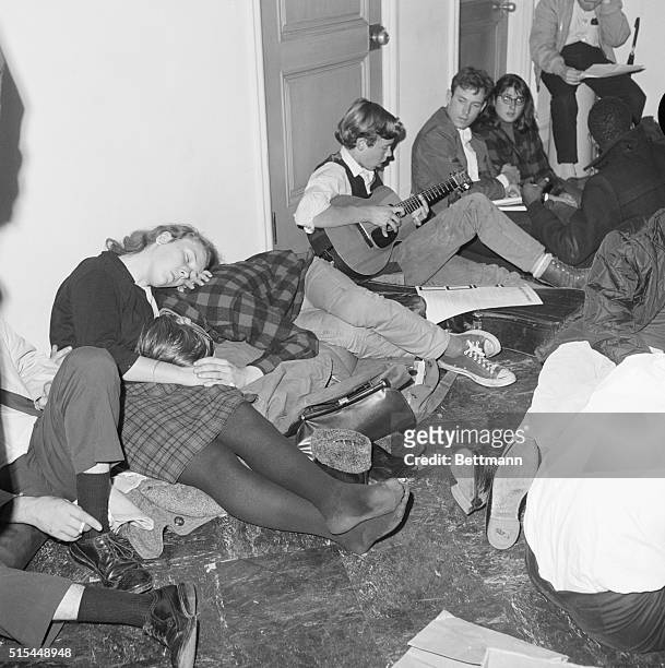 Berkeley, CA- A University of California demonstrator plays guitar, while two other demonstrators curl up together for a "cat-nap." Some 1,000...