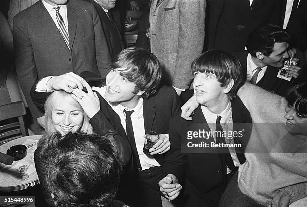 New York, NY- John Lennon, the only married member of the Beatles, enjoys a night out with his wife, Cynthia, after appearing with the other three...