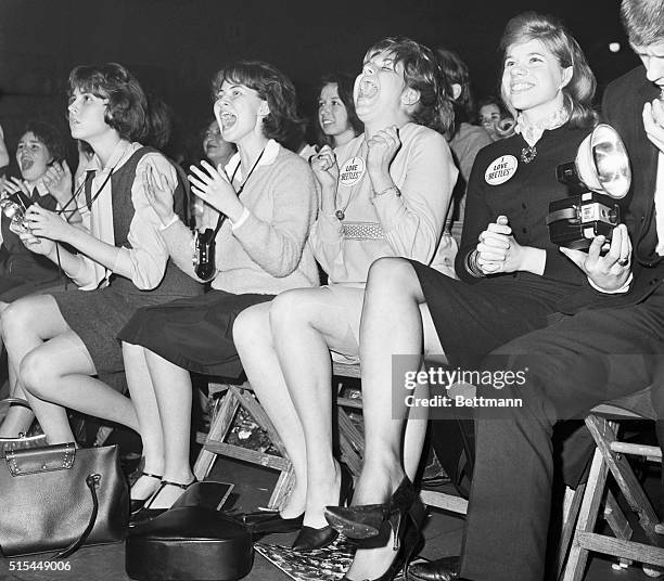 Teenage girls scream with enthusiasm as they watch their heroes, The Beatles, perform at the Washington, DC Coliseum.