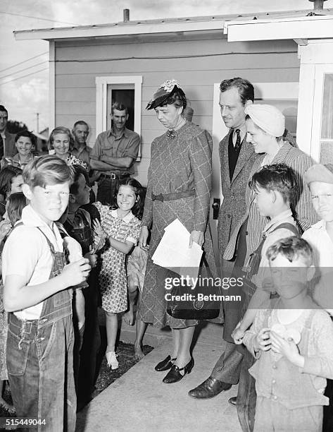 Visalia, CA- Mrs. Franklin D. Roosevelt smiles down at a group of happy children in the Federal Government's migratory workers' camp here,where she...