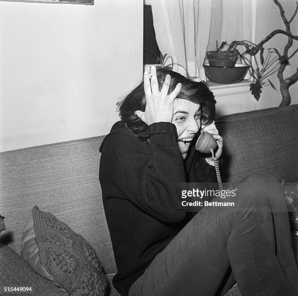 New York, NY- Actress Anne Bancroft wrinkles up with glee as she phones relatives with the news from her home in New York April 8, after winning the...