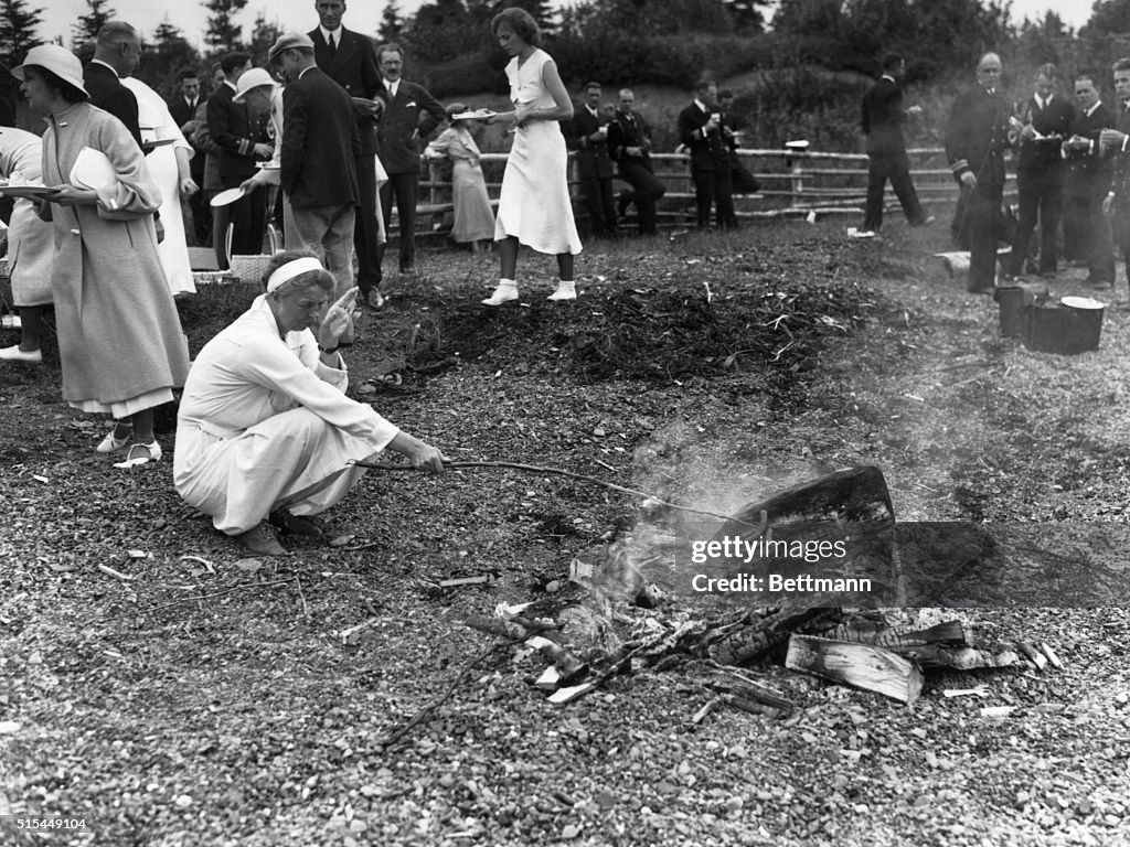 Eleanor Roosevelt Roasts Hot Dog on Camp Fire