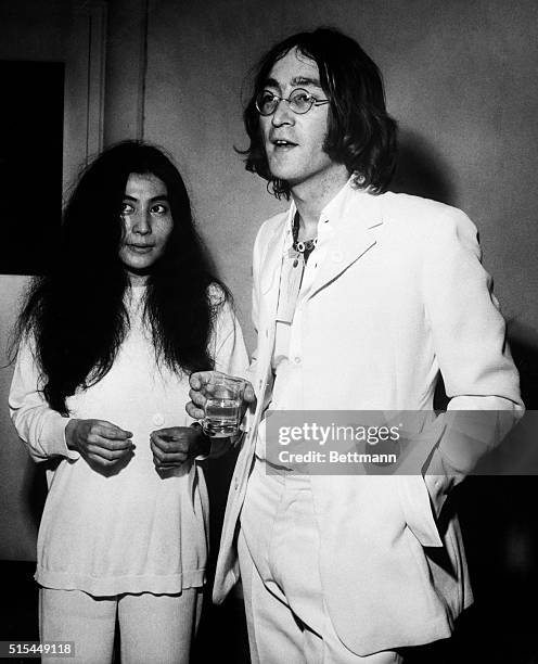 London, England- Beatle John Lennon chats with Japanese artist Yoko Ono at the Mayfair Gallery here late July 1, where they attended an exhibition of...