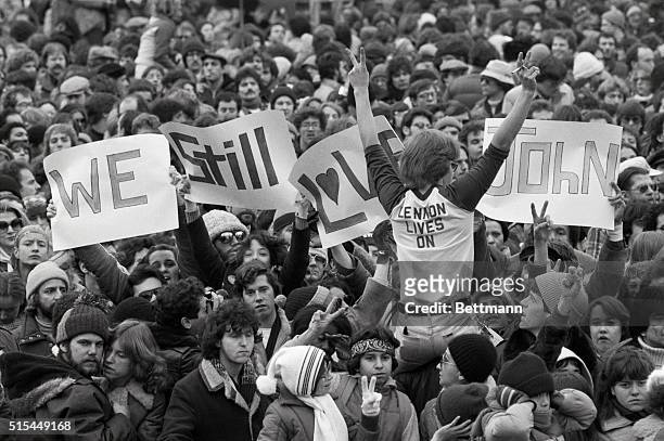 New York, NY- Some of the 50,000 persons express their sentiments to slain former Beatle John Lennon during a silent vigil for Lennon in Central Park...