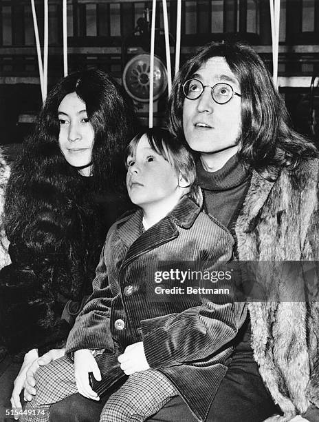 London, England- John Lennon, a member of the Beatles, was entertained by another singing group 12/10 when he took his five-year-son, Julian, to the...