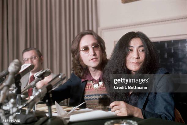 New York, NY: John Lennon, a former "Beatle" with wife, Yoko Ono, during a press conference. Slide shows a waist up of the couple looking to the...