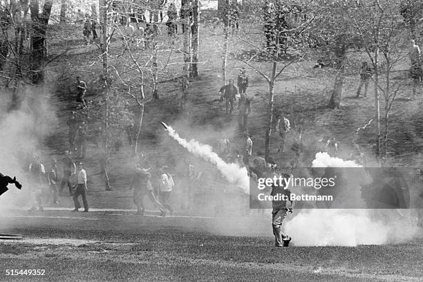 Kent, OH- Kent State University student hurls tear gas cannister back towards National Guardsmen as the military is called out May 4th to put down...