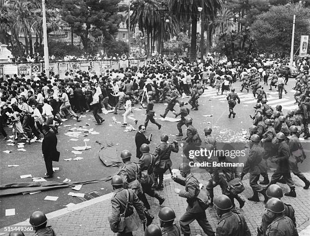 Rome, Italy- Club-swinging riot police charge into a group of university student demonstrators protesting U.S. Policy and involvement in Vietnam. The...