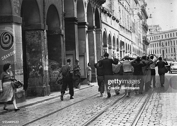 Algiers, Algeria- Women watch as a group of arrested suspects are marched away by French troops during the search of the Casbah for rebels, guns,...