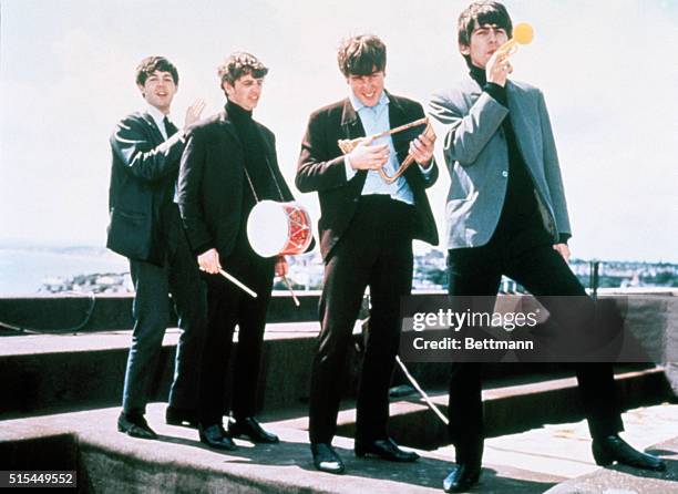 London, England: The Beatles clown on a London rooftop, left to right: Paul McCartney, Ringo Starr, John Lennon, and George Harrison.