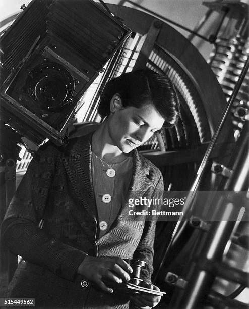 Portrait of internationally famous industrial photographer Margaret Bourke-White, holding a camera.