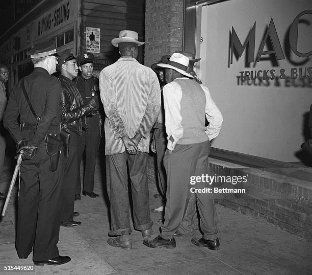 Los Angeles, CA- Los Angeles policemen examine draft credentials, as they continue the roundup of zoot-suit suspects in the aftermath of the sixth...