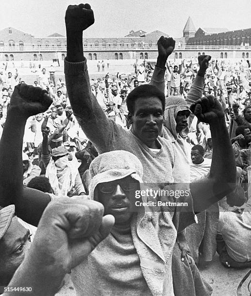 Attica, New York-: Inmates at the Attica State Correctional Facility raise their fists in support of their demands while other leaders of the prison...