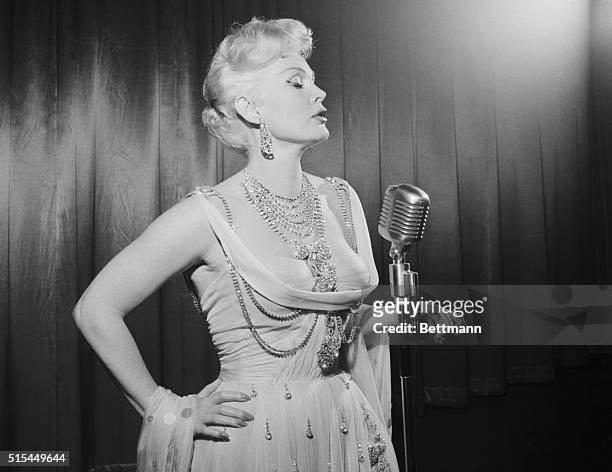 Las Vegas, NV- Zsa Zsa Gabor models a pale peach colored panelled dress topped only with a frosting of simulated diamonds which she will wear here...