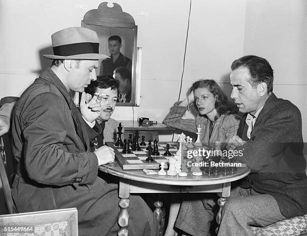 The intent gents are screen lovers Charles Boyer and Humphrey Bogart, during a game of chess on the set of Warners' "Confidential Agent," in which...