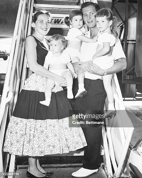 Country gospel singer Pat Boone stands with his wife and three daughters before boarding a plane in New York City. The family is : Shirley, Deborah...