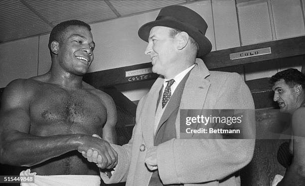 Cleveland, OH- Cleveland Browns coach Paul Brown congratulates rookie fullback Jim Brown after he scored four touchdowns against the L.A. Rams,...