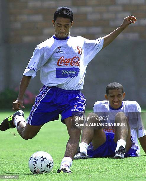 Nolberto Solano of Peru tries a penal shot while Jose Soto, his teammate looks at him during the training in Peru, Lima 28 March 2000. El volante de...