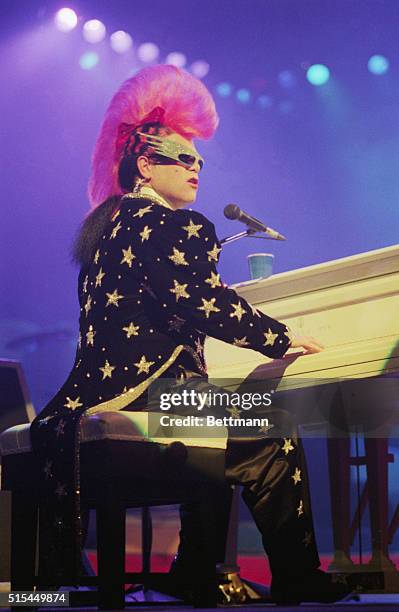 Elton John, sporting one of his more unusual hairdos, performing at the Universal Amphitheatre.