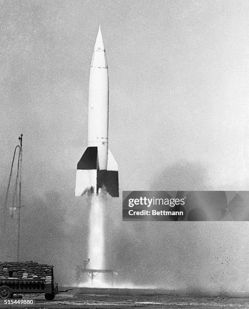 White Sands, NM- Amid a roar and a spurt of flame, a captured V-2 rocket, with a flying laboratory for a warhead, begins its 65-mile flight above the...