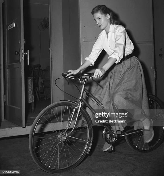 Hollywood, CA-: Screen actress Lauren Bacall wastes no time as she leaves movie set on bicycle after day's shooting. She's married to Humphrey Bogart.