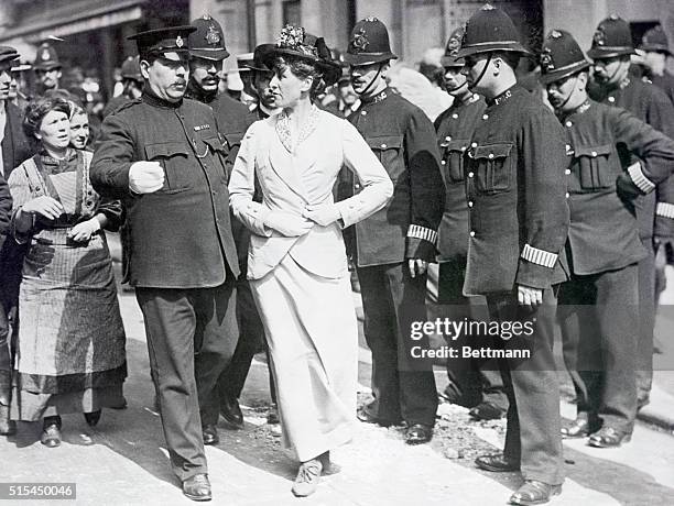 English suffragist about to be arrested by stern but polite English policemen. Photograph, ca. 1912.