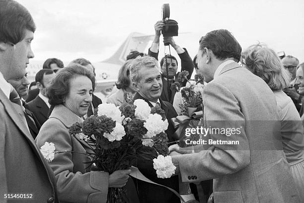 New York, NY- : Mrs. Nicolae Ceausescu, wife of the Romanian president holds a bouquet of flowers while her husband is greeted by an unidentified...