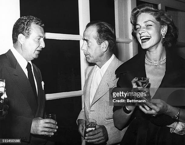 Lauren Bacall at a Hollywood party with Humphrey Bogart and Phil Harris. Undated photograph.