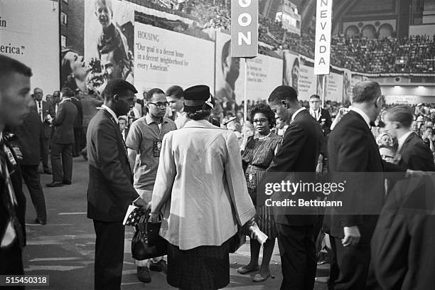 Six members of the Mississippi Freedom Democratic Party form a circle beside Mississippi's main delegation to the Democratic National Party in...