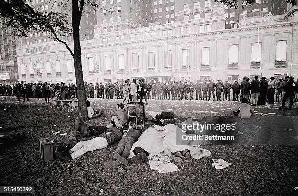 Chicago, Illinois- The first light of day reveals a group of Yippies sleeping peacefully under the watchful eyes of National Guard troops in...