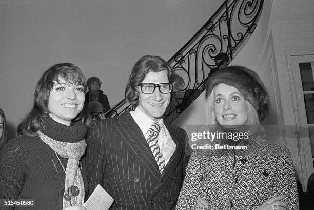 Paris, France- Fashion designer Yves Saint Laurent is flanked by two of the most prominent women attending his spring-summer collection show here...