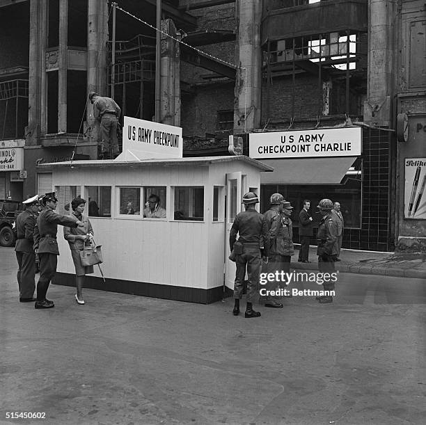 West Berlin, Germany- United States troops at the Frederick Street checkpoint in West Berlin stand guard at a weatherproof wooden building that has...