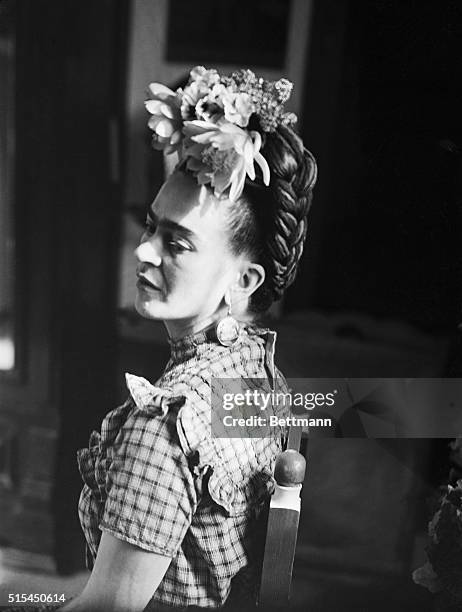 Seated profile photograph of Frida Kahlo , Mexican painter and wife of Diego Rivera.
