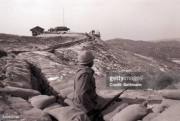 Demilitarized Zone, Korea-A soldier watches for possible guerrilla action from the north as he stands on a hill bordering the DMZ between North and...
