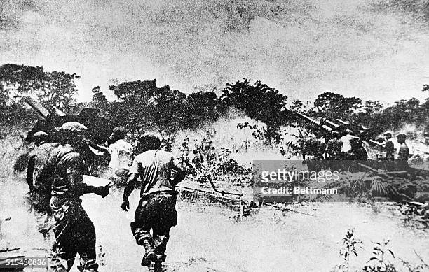 Miami, FL- In this photograph taken from the newspaper "Revolusion," large artillery pieces are shown firing on Cuban rebels as they invade a...
