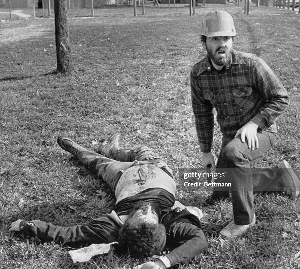 Communist Kneels with Pistol by Victim