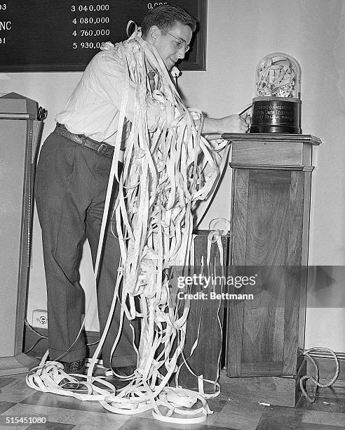 New York, New York- An employee in a New York City brokerage house get all tangled up in ticker tape during the wild day in Wall Street when stock...