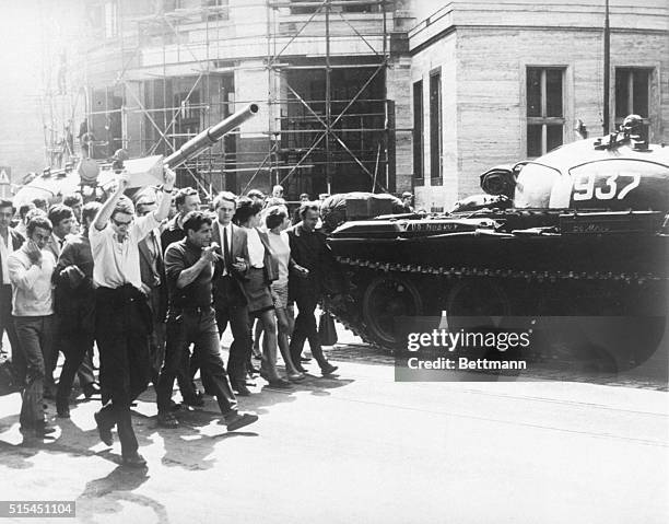 Bratislava, Czechoslovakia- With the Czech flag emblem raised and with arms linked the young people of Bratislava march down the street past the...