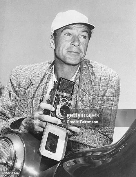 Los Angeles, CA- Hollywood screen star Gary Cooper reverses the usual procedure and gets behind the camera. Gary will be back in his usual place in...