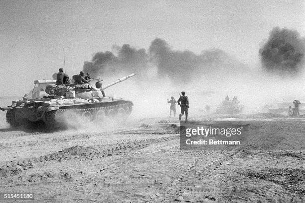Basra, Iraq- Iraqi troops riding in Soviet-made tanks head for a pontoon bridge in an effort to cross the Karum River northeast of Khurramshahr. The...